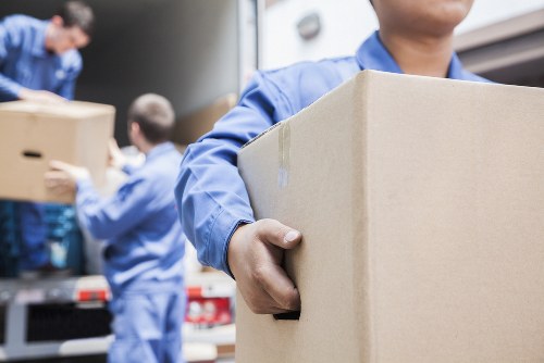 Professional team handling furniture for pick-up in Soho storage facility